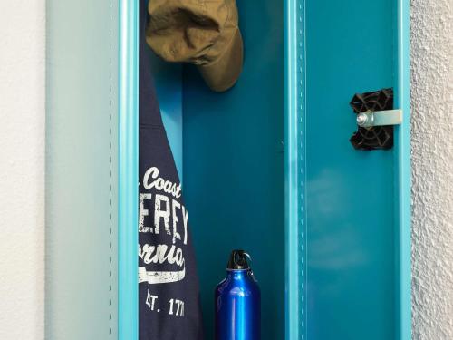 a blue door with a tie and a soda can at hotelF1 Rungis Orly in Rungis