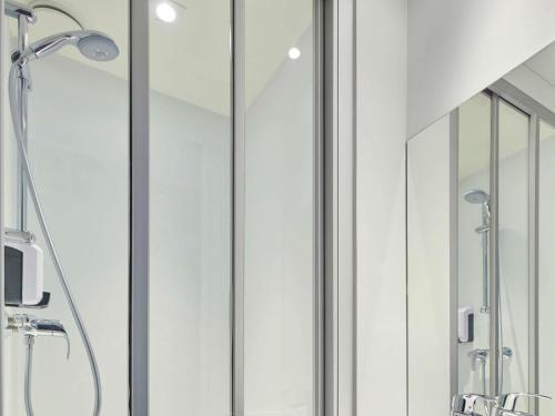 a bathroom with a shower with glass doors at hotelF1 Chambéry Nord Rénové in Chambéry