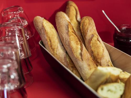a tray of bread with cheese and dips on a table at hotelF1 Clermont Ferrand Est in Clermont-Ferrand