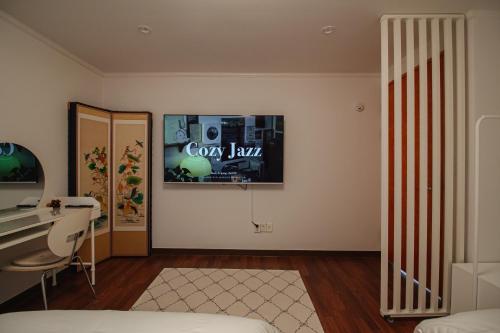 a room with a bed and a desk and a mirror at Stay Vibe Healing House in Seoul