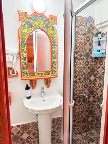a bathroom with a sink and a shower at Riad Las mil y una noches 2 Tetuan in Tetouan