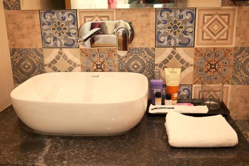 a white sink in a bathroom next to a sink at Kunj - A Boutique Hotel By Shivaneel Hospitality in Pushkar