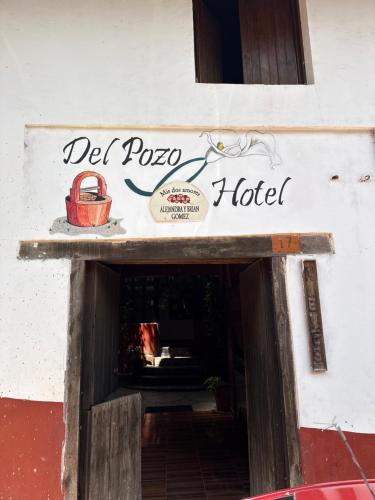 a sign that reads del pago hotel on a building at Hotel del Pozo in San Sebastián del Oeste