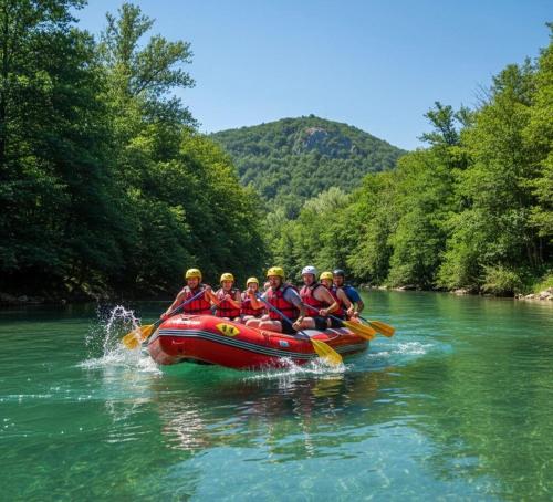 a group of people in a raft on a river at Whisper of the Pliva in Šipovo