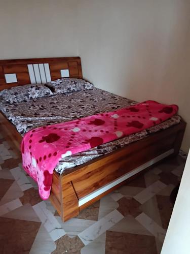 a bedroom with two beds with a pink blanket at Camping blue sky heaven malshej in Malshej Ghat