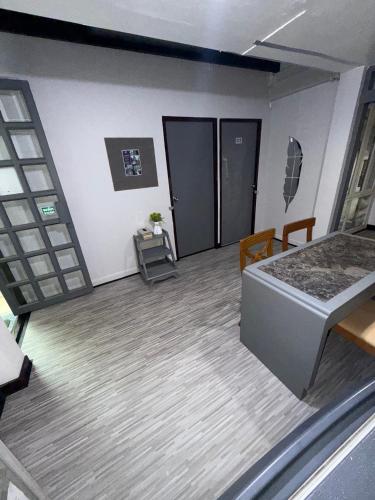 a bedroom with a bed and a table and chairs at Ree House- Sukhumvit 23 in Bangkok