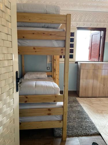 a bunk bed in a room with a bunk bed in a room at Zeri Surf Camp in Tiguemmi nʼAït Bihi