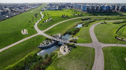 an aerial view of a bridge over a river at Comfy Home in Harbour Landing - Regina in Regina