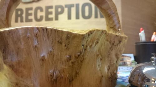 a wooden vase sitting on a table with a sign at Family Hotel Eterno in Tsigov Chark