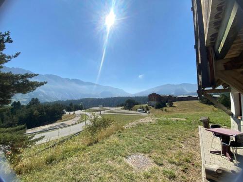 a view from the porch of a house with the sun shining at Les Chalets De Superd Bleuet - 2 Pièces pour 4 Personnes MAE-8884 in Le Dévoluy