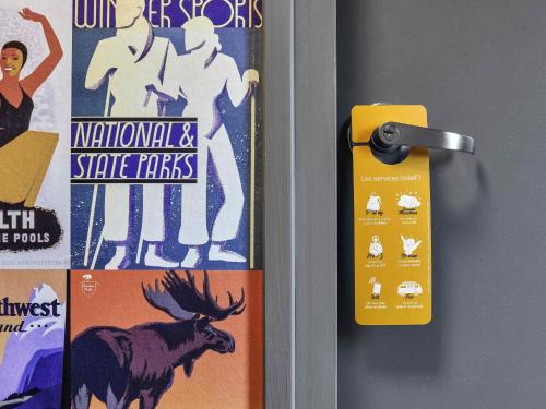 a door handle with a sign on a door at hotelF1 Paris Villemomble in Villemomble