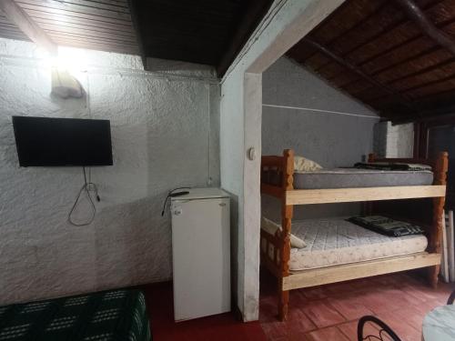 a room with two bunk beds and a television at Apartamentos Laguna Merin Rincón del Lago in Lago Merin