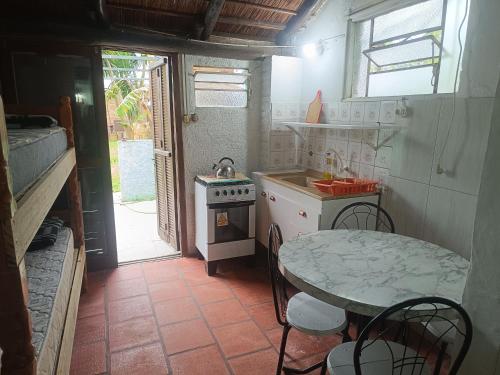 a small kitchen with a table and a stove at Apartamentos Laguna Merin Rincón del Lago in Lago Merin