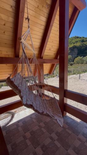 a hammock hanging from the roof of a porch at Whisper of the Pliva in Šipovo