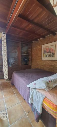 a bedroom with a bed in a room at Chales praias de Ubatuba in Ubatuba