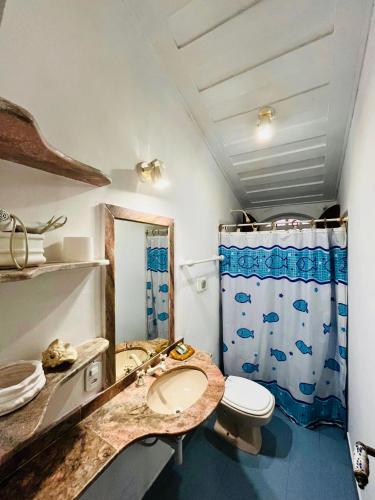 a bathroom with a sink and a toilet and a shower at Origem Buziana in Búzios