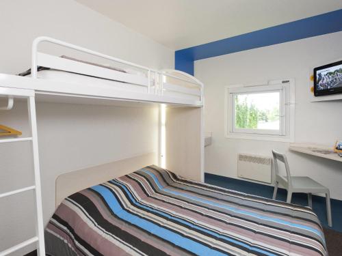 a small bedroom with a bunk bed and a desk at hotelF1 Compiègne in Venette
