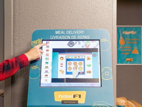 a person is pointing to ahealth delivery innovation device at hotelF1 Brétigny sur Orge in Brétigny-sur-Orge