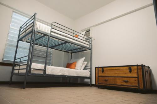 a bedroom with a bunk bed with a wooden dresser at Oceania Villas in Culebra