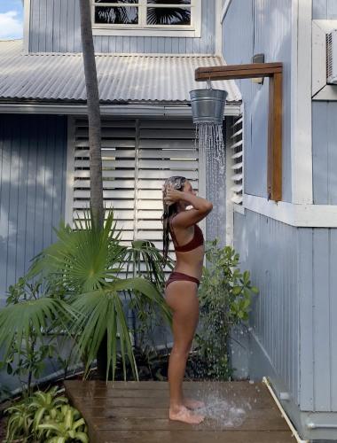 a woman in a bikini standing outside of a building at Oceania Villas in Culebra