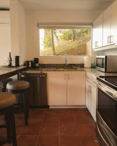 a kitchen with a sink and a window at Oceania Villas in Culebra