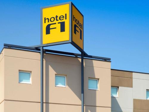 a sign for a hotel on top of a building at hotelF1 Avranches Baie Du Mont Saint Michel in Saint-Quentin-sur-le-Homme