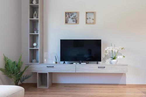 a living room with a television on a table at 2BR at Artist's Palace - Skanderbeg Square Views in Tirana