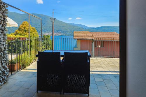 a table and chairs on a balcony with a view at Casa A&E - Panoramic Lake Orta Views in Oira