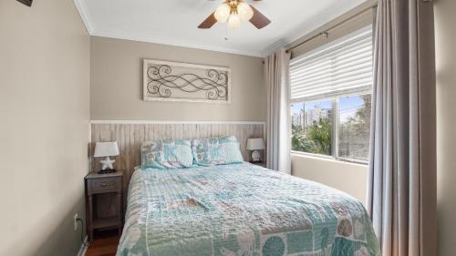 a bedroom with a bed and a window at Great Vibes in Panama City Beach