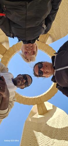 a group of people standing in a circle at Reagan House in Aswan