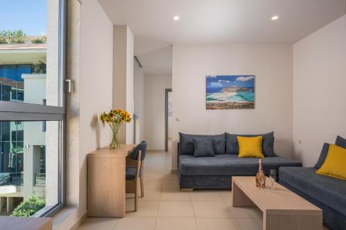 a living room with a couch and a table at Trianon Luxury Apartments & Suites in Chania Town