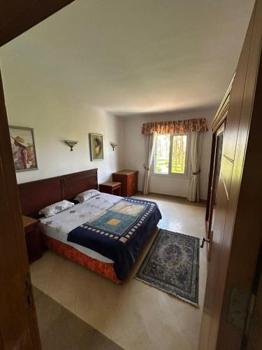 a bedroom with a large bed and a window at apartment on the beach inside a hotel in Sharm El Sheikh