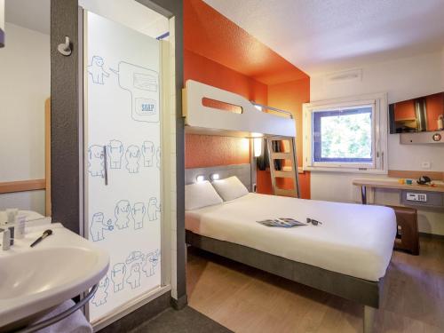 a hotel room with a bed and a sink at Ibis Budget Marseille Timone in Marseille