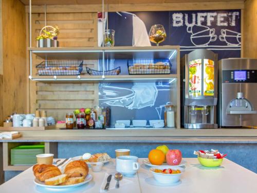 a table with croissants and other food on it at Ibis Budget Marseille Timone in Marseille
