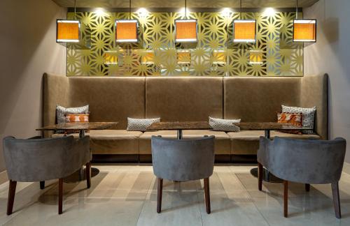 a restaurant with two tables and a couch at Hotel Chico 97 By OxoHotel in Bogotá