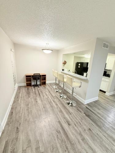 an empty living room with chairs and a kitchen at Quiet Quarter 1Br1Ba by Dallas north tollway and Med in Addison