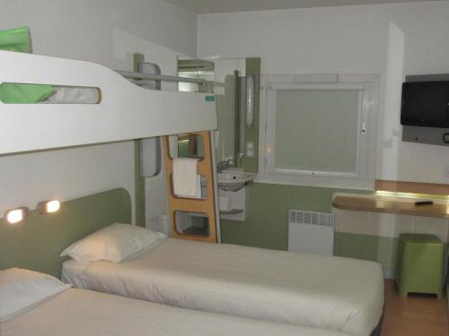a bedroom with two bunk beds and a sink at IBIS Budget Aix en Provence Est Le Canet in Meyreuil