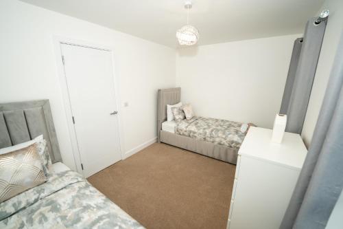 a bedroom with two beds and a closet at Chapel Waters Sleeps 6 with Private Parking in Lower Bradway