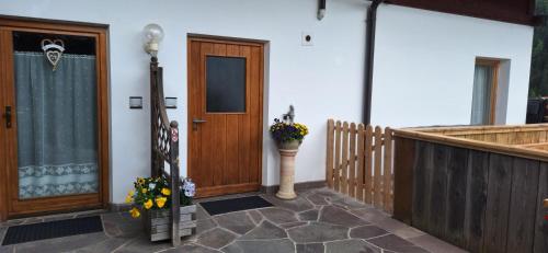 a front door of a house with flowers on the porch at Apartments Insam in Santa Cristina in Val Gardena