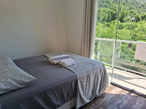 Una cama o camas en una habitación de Apartamento Lagoa da Conceição