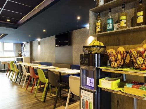 a row of tables and chairs in a restaurant at ibis budget Porte D'Orleans in Paris
