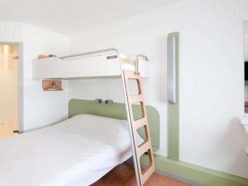 a bunk bed with a ladder in a room at ibis budget Poitiers Sud in Poitiers