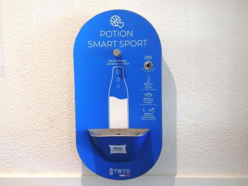 a blue sign that saysutions smart spot at ibis budget Poitiers Sud in Poitiers