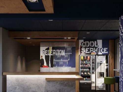 a store with a counter and a sign that reads good service at ibis budget Poitiers Nord Futuroscope in Chasseneuil-du-Poitou