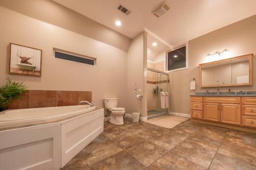 a bathroom with a tub and a toilet and a sink at Historic Mountain Retreat - Near Boreal - 3 Kings in Emigrant Gap