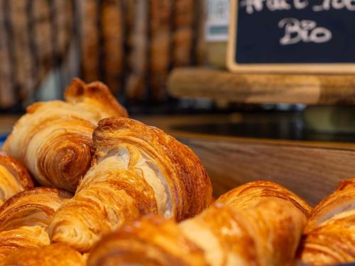 a bunch of croissants sitting on top of a table at ibis budget Caen Mondeville in Mondeville