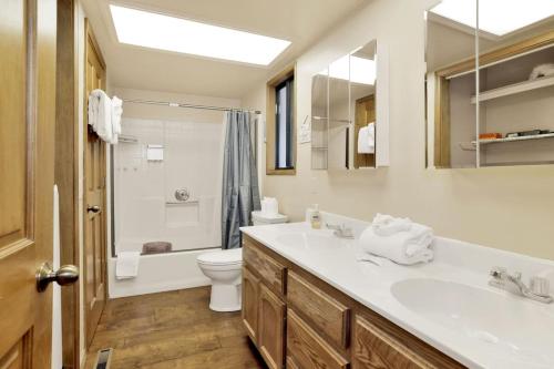 a bathroom with a sink and a toilet at Moonridge Treehouse - Relaxing Lofty Big Bear Hillside Retreat- Great Deck Views- Central in Big Bear Lake