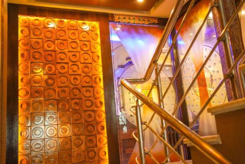 a set of stairs leading up to a glass door at Hotel O Blue Diamond Hotel And Restaurant in Hugli