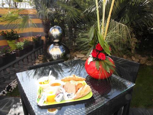 a black table with a plate of food on it at Hotel Ibis Budget Nice Palais Nikaia in Nice