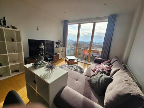 a living room with a couch and a large window at 4 Beds Luxury Flat with the Best London View in London